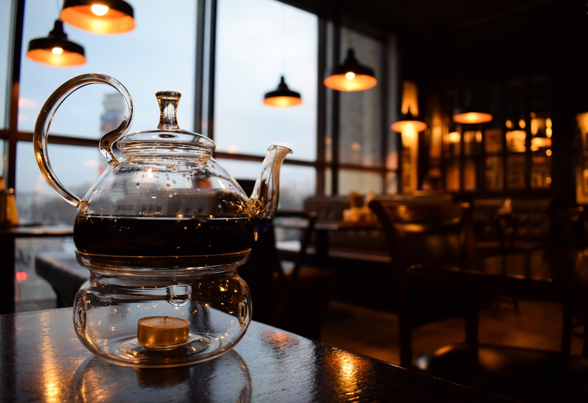 Measuring dried herbs into a teapot